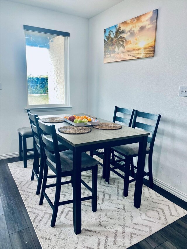 dining space featuring wood-type flooring