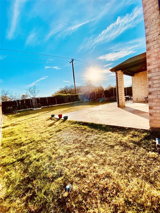 view of yard with a playground and a patio area