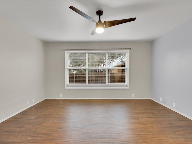 empty room featuring ceiling fan and dark wood-type flooring