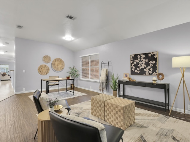 living room with wood-type flooring and vaulted ceiling