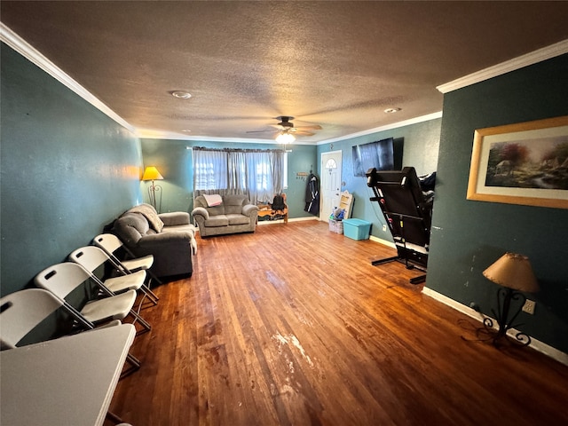 living room with crown molding, hardwood / wood-style floors, ceiling fan, and a textured ceiling