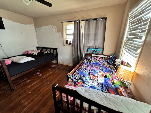 bedroom featuring dark hardwood / wood-style floors and ceiling fan