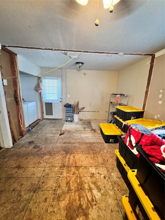 basement with a textured ceiling and separate washer and dryer