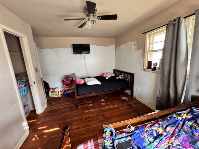 bedroom with ceiling fan and dark hardwood / wood-style flooring