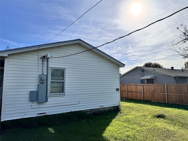 view of side of home with a lawn