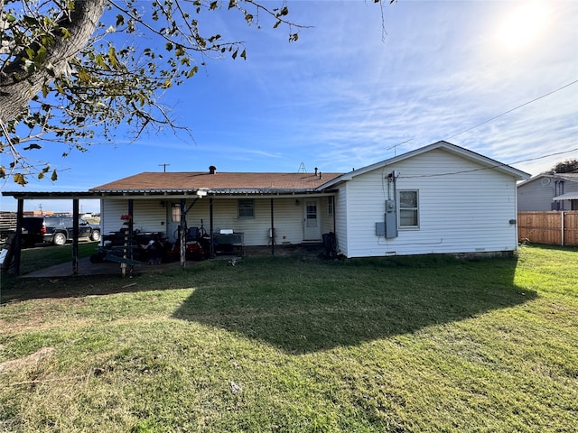 back of house featuring a yard