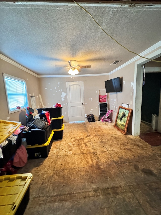 living room featuring a textured ceiling, ceiling fan, and crown molding