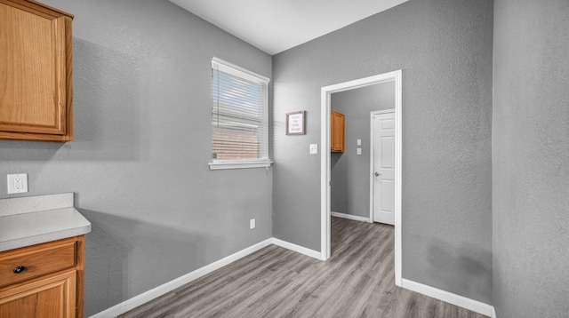 interior space with baseboards and light wood-style floors