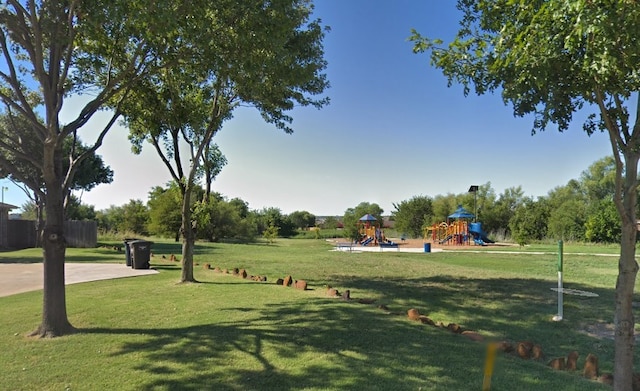 view of community with playground community and a yard