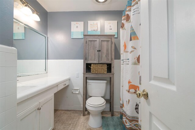 full bathroom featuring vanity, tile patterned floors, crown molding, toilet, and shower / tub combo with curtain