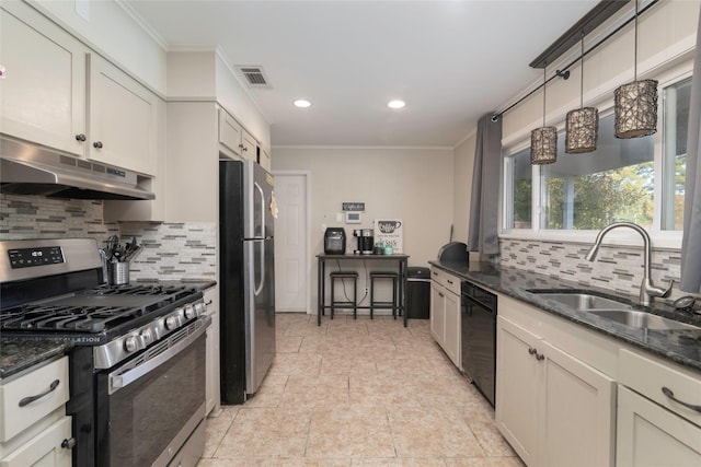 kitchen with backsplash, stainless steel appliances, crown molding, sink, and dark stone countertops