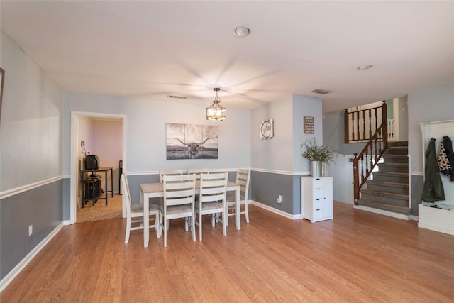 dining room featuring a chandelier and light hardwood / wood-style floors