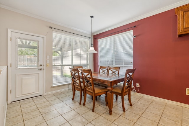 tiled dining space featuring a wealth of natural light and crown molding