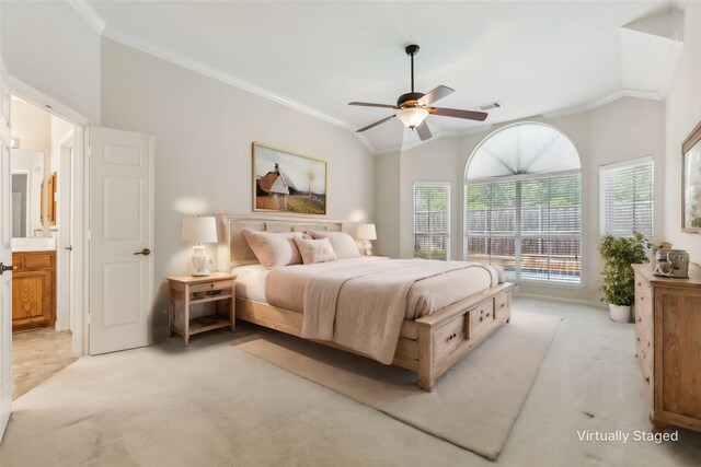 bedroom featuring lofted ceiling, ensuite bathroom, crown molding, ceiling fan, and light colored carpet