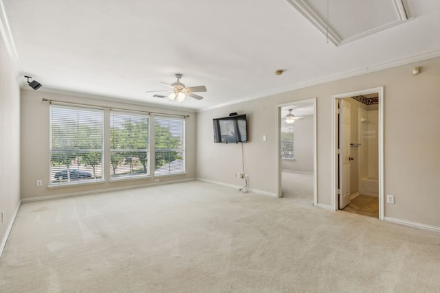 spare room with crown molding, ceiling fan, and light colored carpet