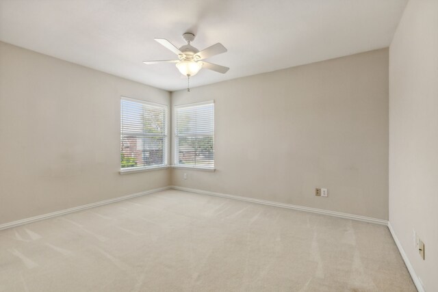 spare room with light carpet and ceiling fan