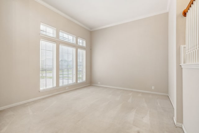 carpeted empty room featuring crown molding