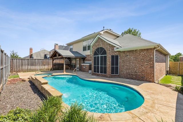 view of pool featuring an in ground hot tub and a patio