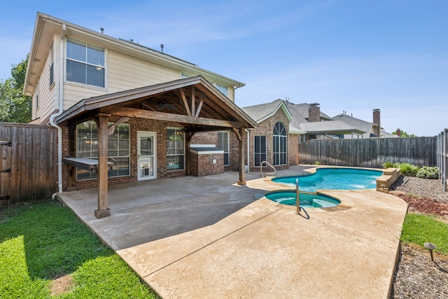 view of pool with a patio area and an in ground hot tub