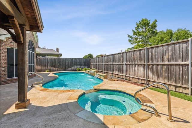 view of pool with an in ground hot tub, pool water feature, and a patio