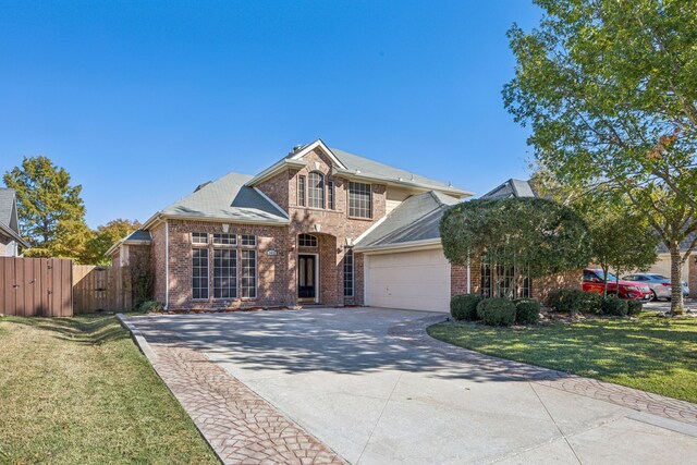 view of front of house featuring a front lawn and a garage