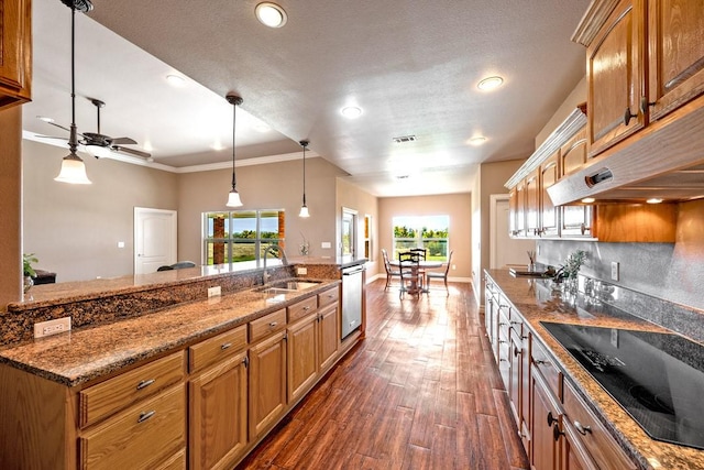 kitchen featuring black electric stovetop, dark wood-style floors, crown molding, stainless steel dishwasher, and a sink