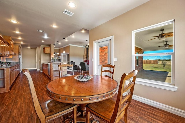 dining space featuring dark wood-type flooring and ceiling fan