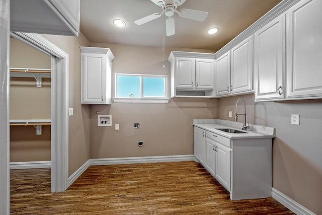 clothes washing area featuring sink, washer hookup, ceiling fan, electric dryer hookup, and dark wood-type flooring