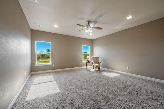 unfurnished room featuring ceiling fan and carpet floors