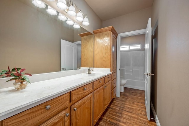 full bathroom with vanity, shower / bathing tub combination, hardwood / wood-style flooring, and toilet