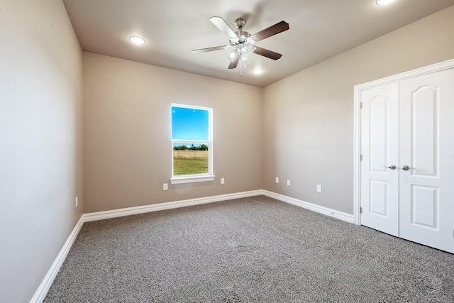 unfurnished bedroom with ceiling fan and carpet flooring