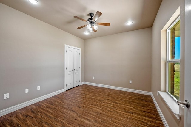 unfurnished room with dark hardwood / wood-style floors and ceiling fan