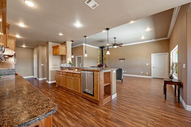 kitchen featuring dishwasher, ceiling fan, hanging light fixtures, dark hardwood / wood-style flooring, and kitchen peninsula