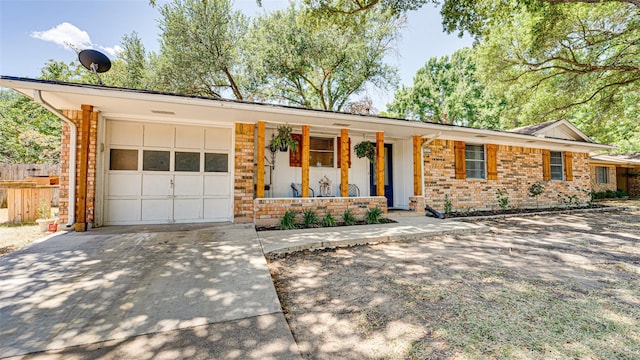 ranch-style home featuring covered porch and a garage