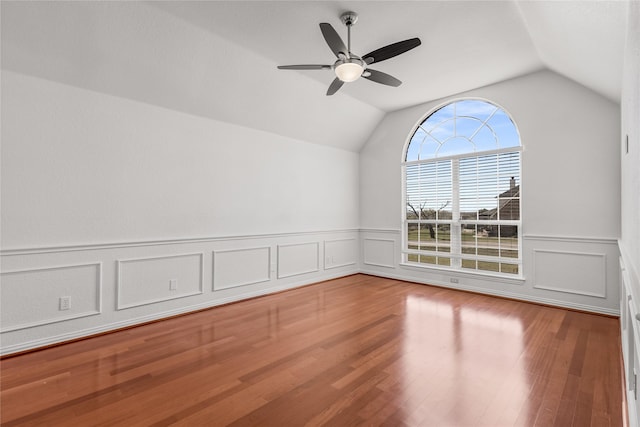 spare room with hardwood / wood-style flooring, ceiling fan, and lofted ceiling