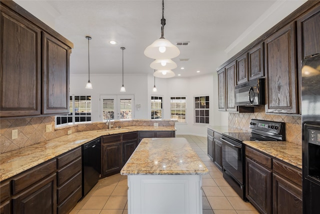 kitchen with pendant lighting, black appliances, a center island, and kitchen peninsula