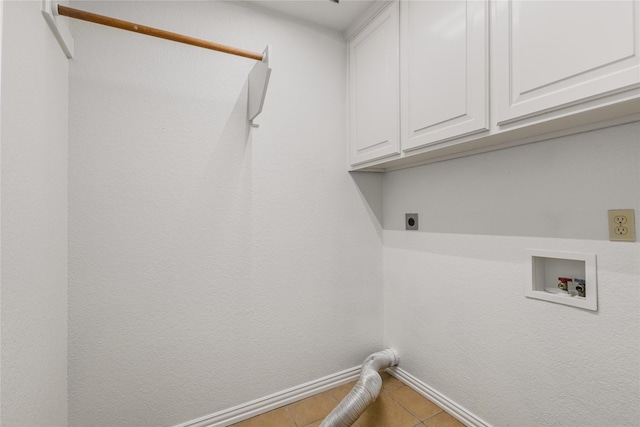 laundry room featuring cabinets, electric dryer hookup, hookup for a washing machine, and tile patterned floors