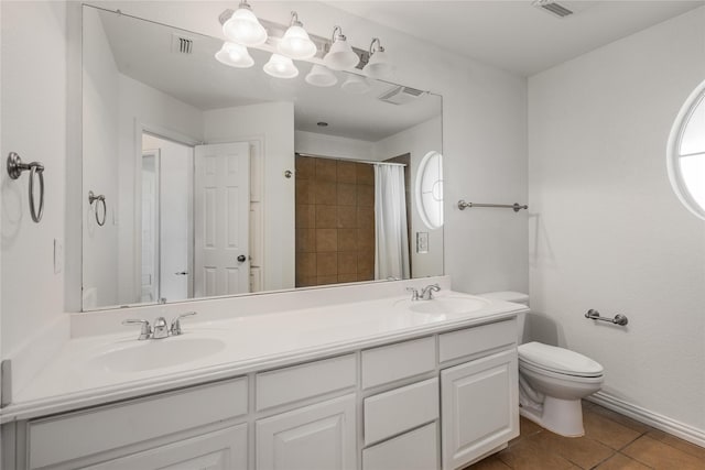 bathroom with tile patterned floors, toilet, curtained shower, and vanity