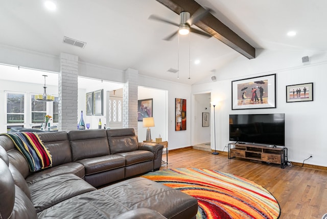 living room featuring ceiling fan, ornamental molding, lofted ceiling with beams, and light wood-type flooring