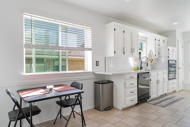 kitchen featuring decorative backsplash, sink, white cabinetry, and black appliances