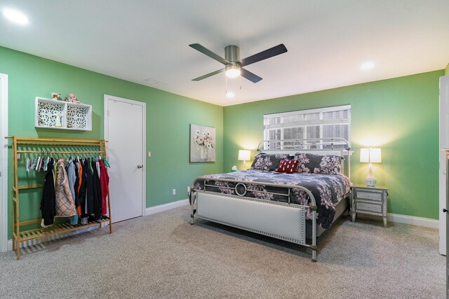 carpeted bedroom featuring a closet and ceiling fan