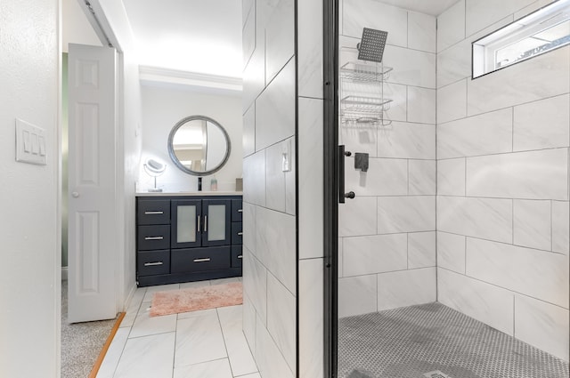 bathroom featuring a tile shower and vanity