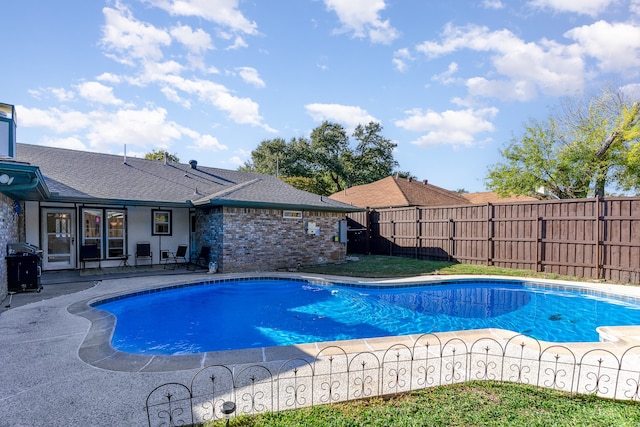 view of pool featuring area for grilling and a patio