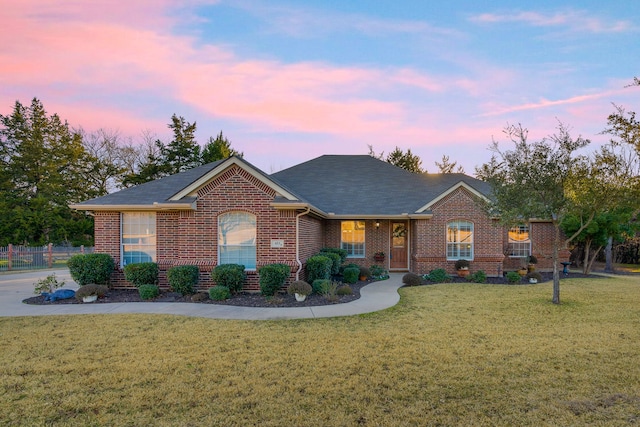 ranch-style home featuring a yard