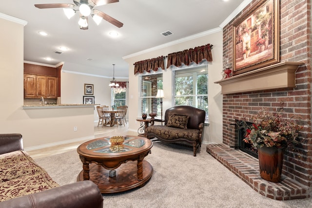 carpeted living room featuring crown molding, sink, ceiling fan, and a fireplace