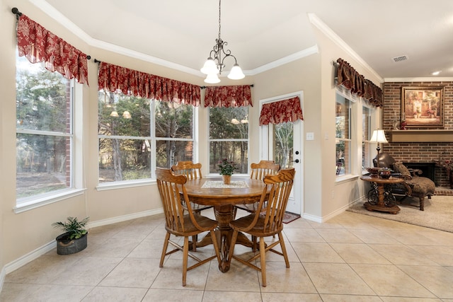 dining space featuring light tile patterned floors, ornamental molding, and a brick fireplace