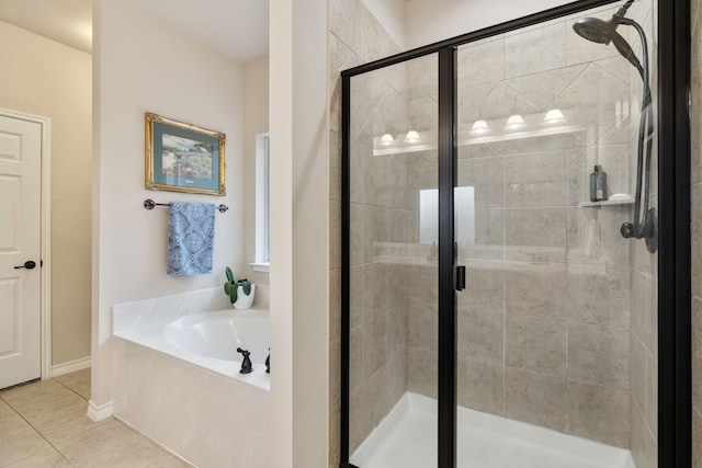 bathroom featuring tile patterned floors and separate shower and tub