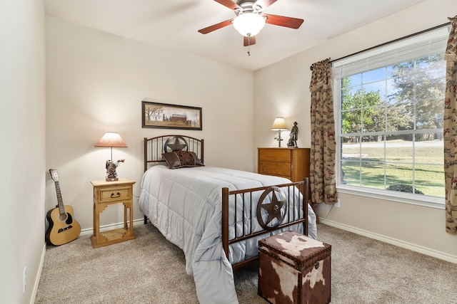 carpeted bedroom with multiple windows and ceiling fan