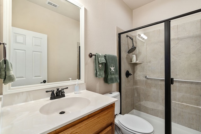 bathroom with vanity, toilet, and an enclosed shower