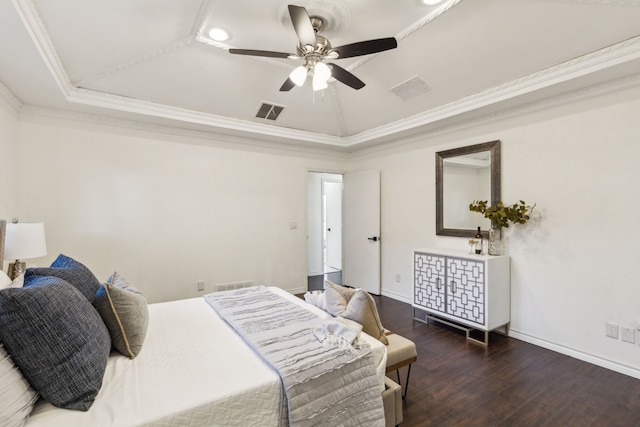 bedroom with crown molding, ceiling fan, a tray ceiling, and dark hardwood / wood-style flooring